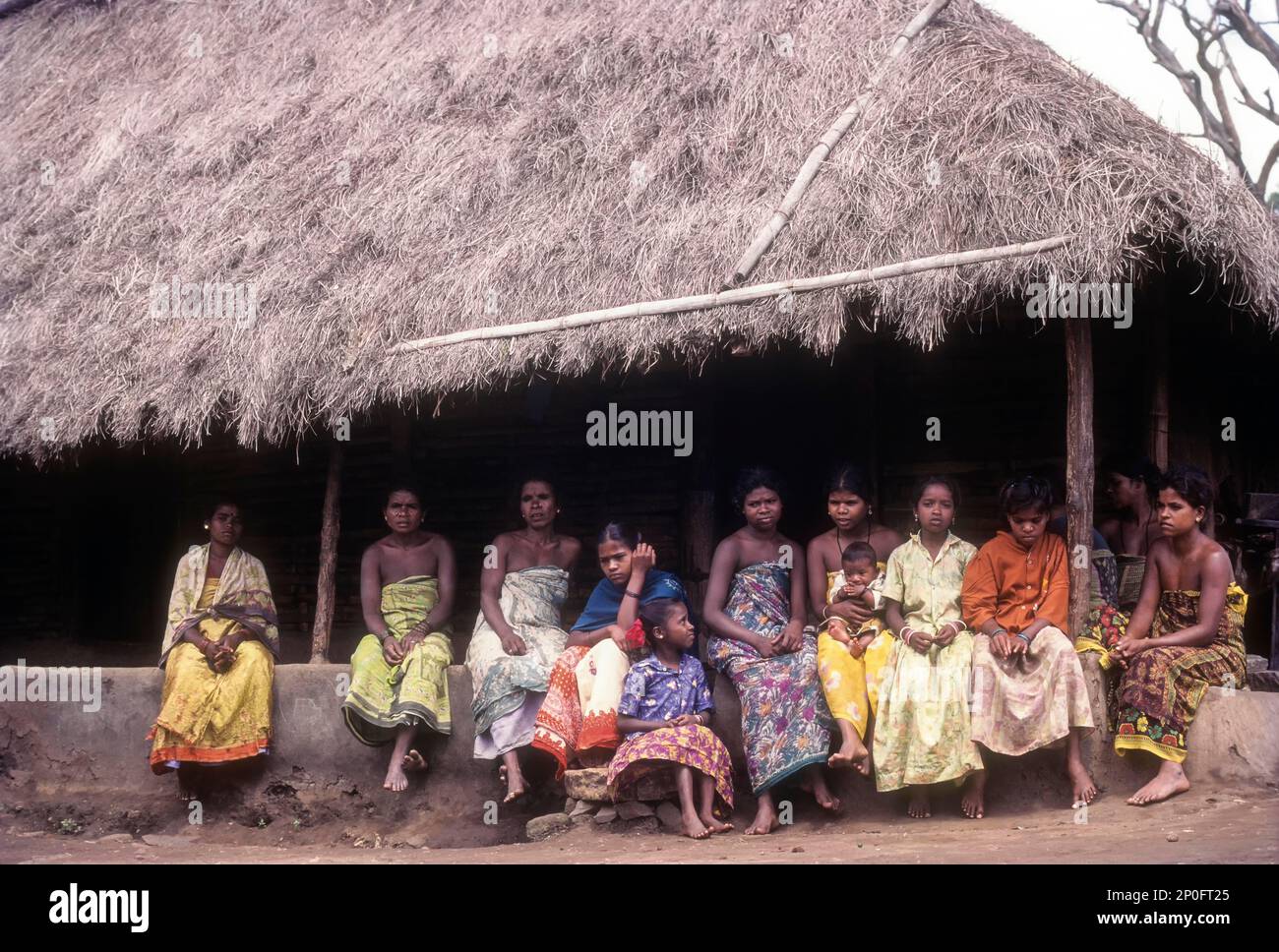A group of Betta Kurumba, hill tribes of Nilgiris sitting the hut at Mudumalai, Tamil Nadu 