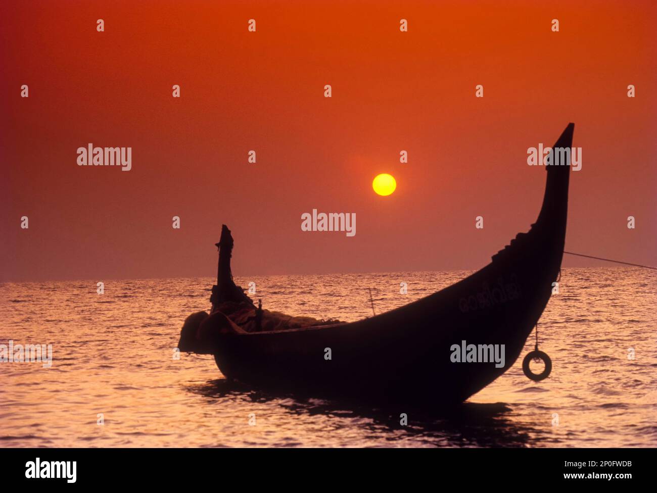 The Setting sun framed by the crescent shaped stern of a Catamaran in ...