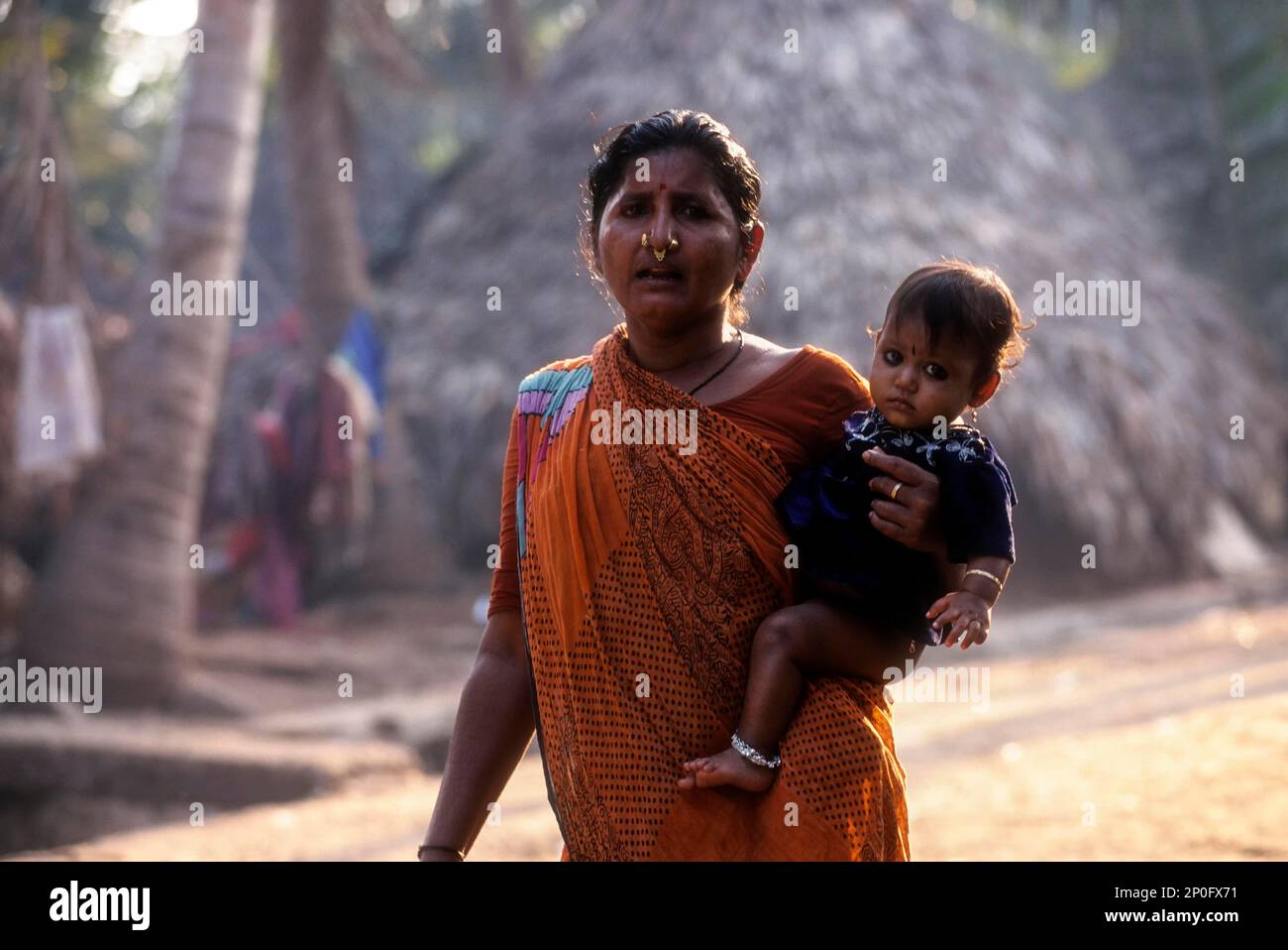 Fisher woman carrying her child at hip, Vishakapatnam Vizag, Andhra ...