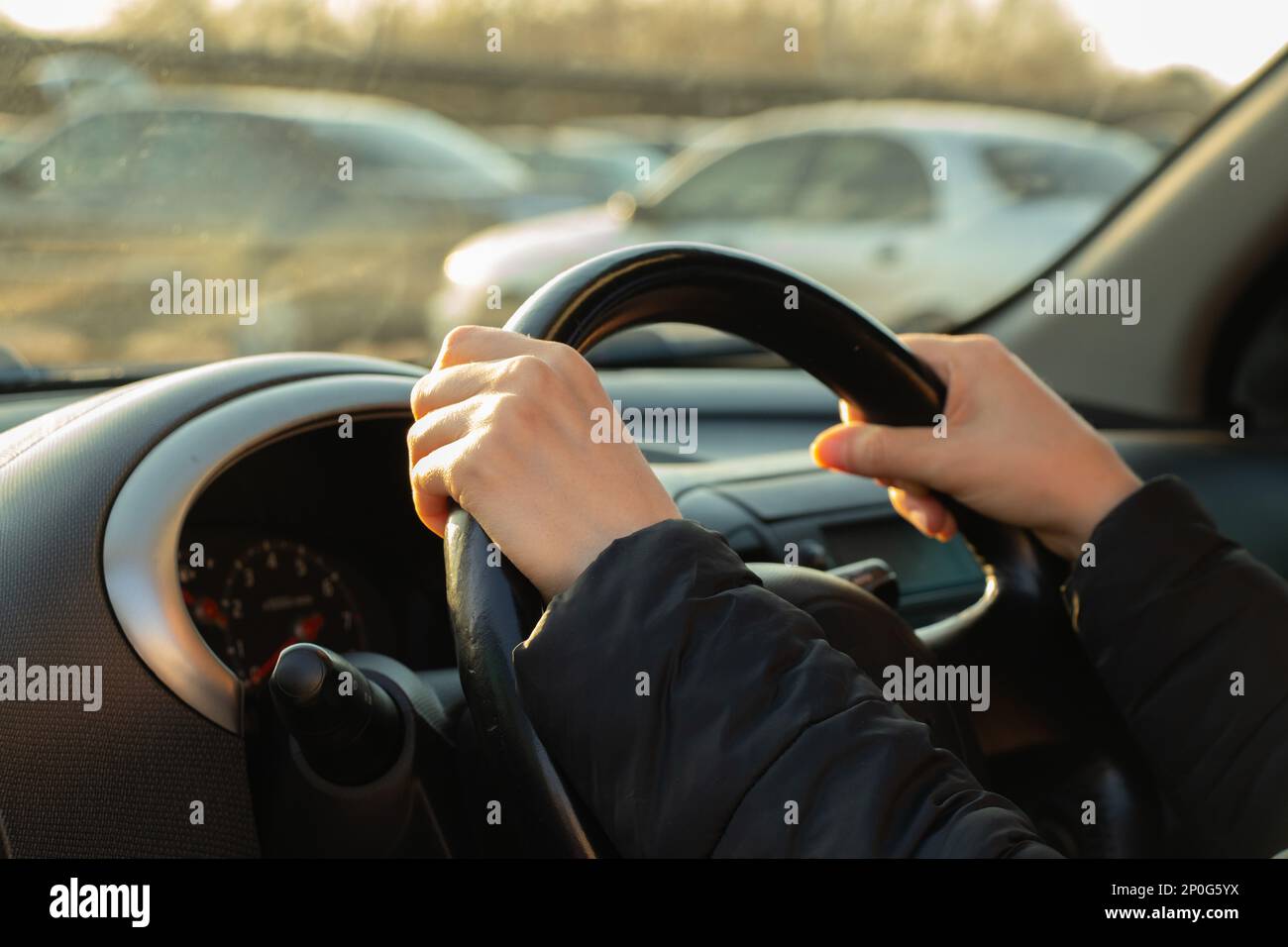 hands on the steering wheel inside the car in the afternoon Stock Photo