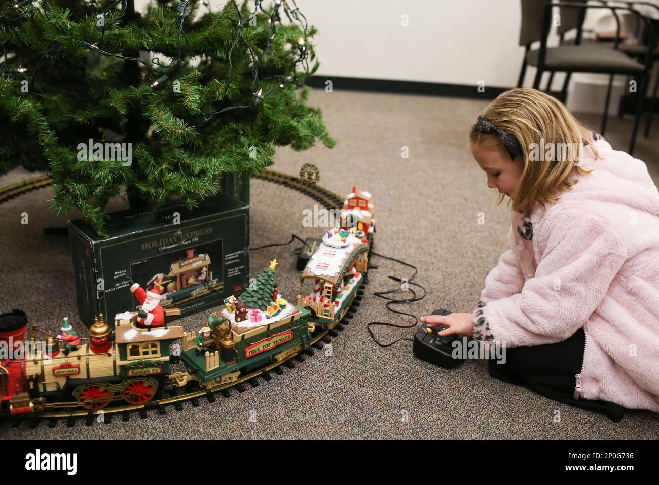 Indigo Empey 5 plays with the Holiday Express train set in the