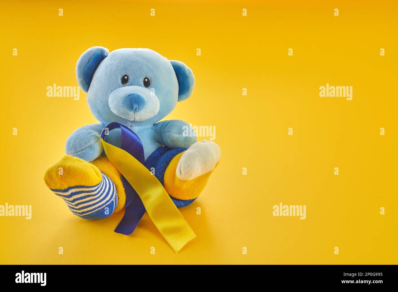 World Down Syndrome day background.Teddy bear with different socks on  yellow background Stock Photo - Alamy