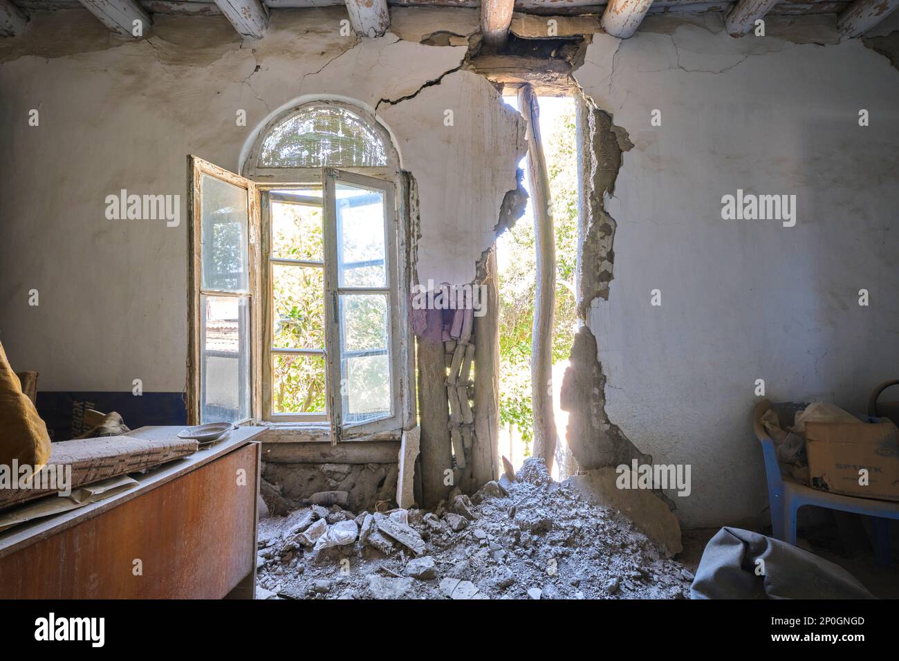 Detail of a side room wall falling apart, with a hole in it. At an old