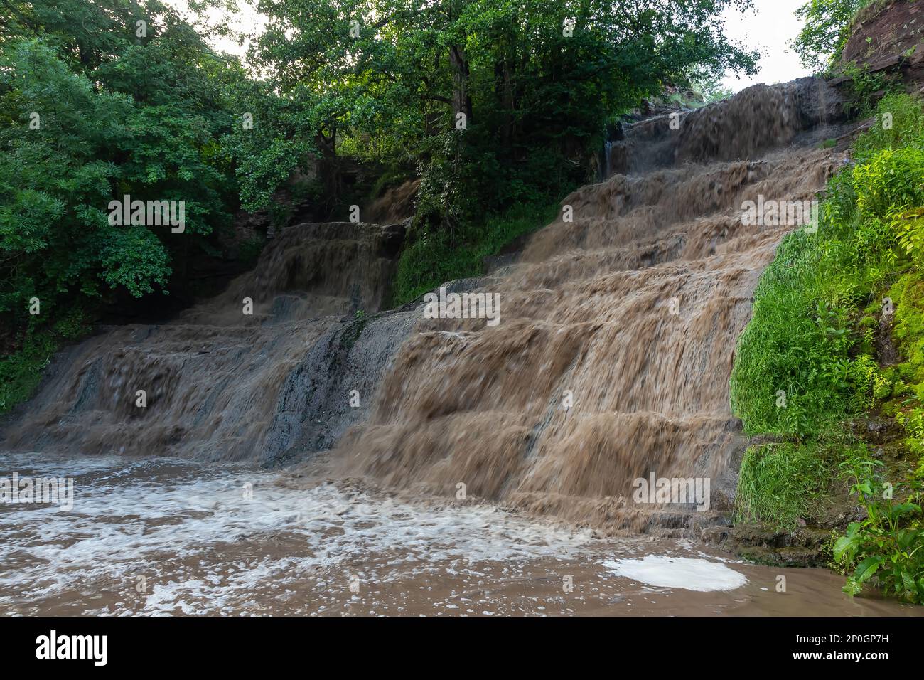 powerful waterfall with dirty water after the hard rain Stock Photo