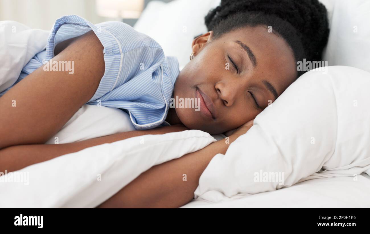 Sleep, bed and relax with a black woman sleeping in the bedroom of her
