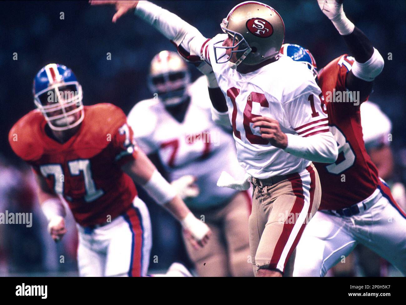 28 Jan 1990: Quarterback Joe Montana of the San Francisco 49ers throws  while pressured during the 49ers 55-10 victory over the Denver Broncos in Super  Bowl XXIV at the Louisiana Superdome in