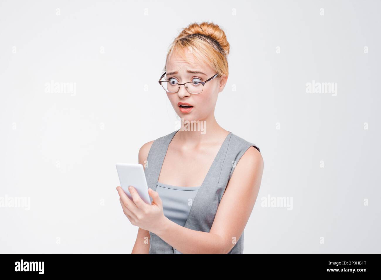 Woman with failure phone. Unreliable software. Stock Photo
