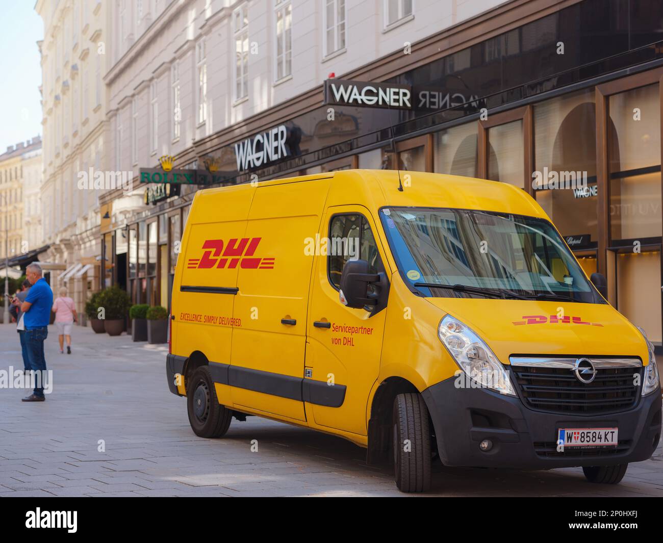 Vienna, Austria - August 11, 2022: yellow DHL courier service delivery van on the street in Munich. DHL is owned by the German postal service Deutsche Post. Stock Photo