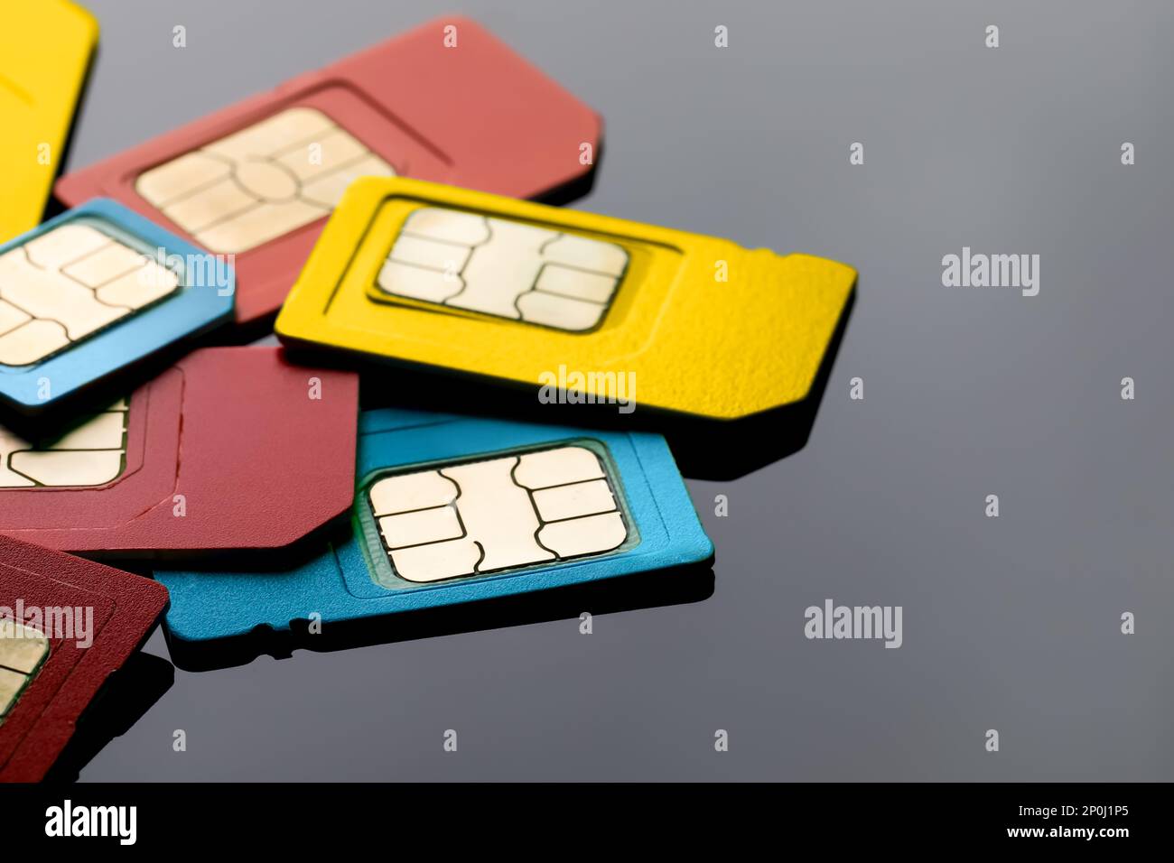 Different SIM cards on grey background, closeup Stock Photo