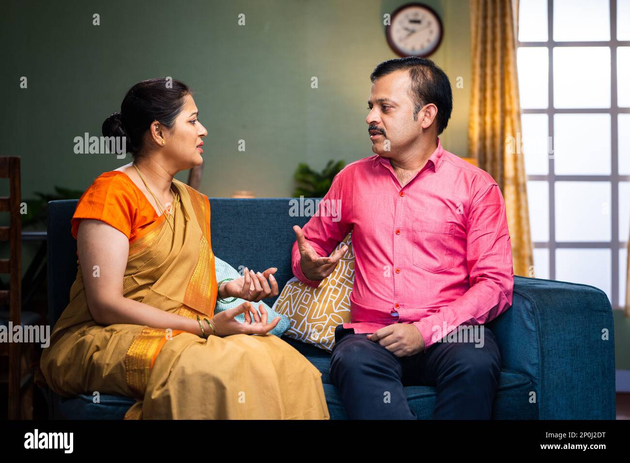 Wife got angry while arguing with husband at home - concept of relationship problems, conflict and unhappy relationship. Stock Photo