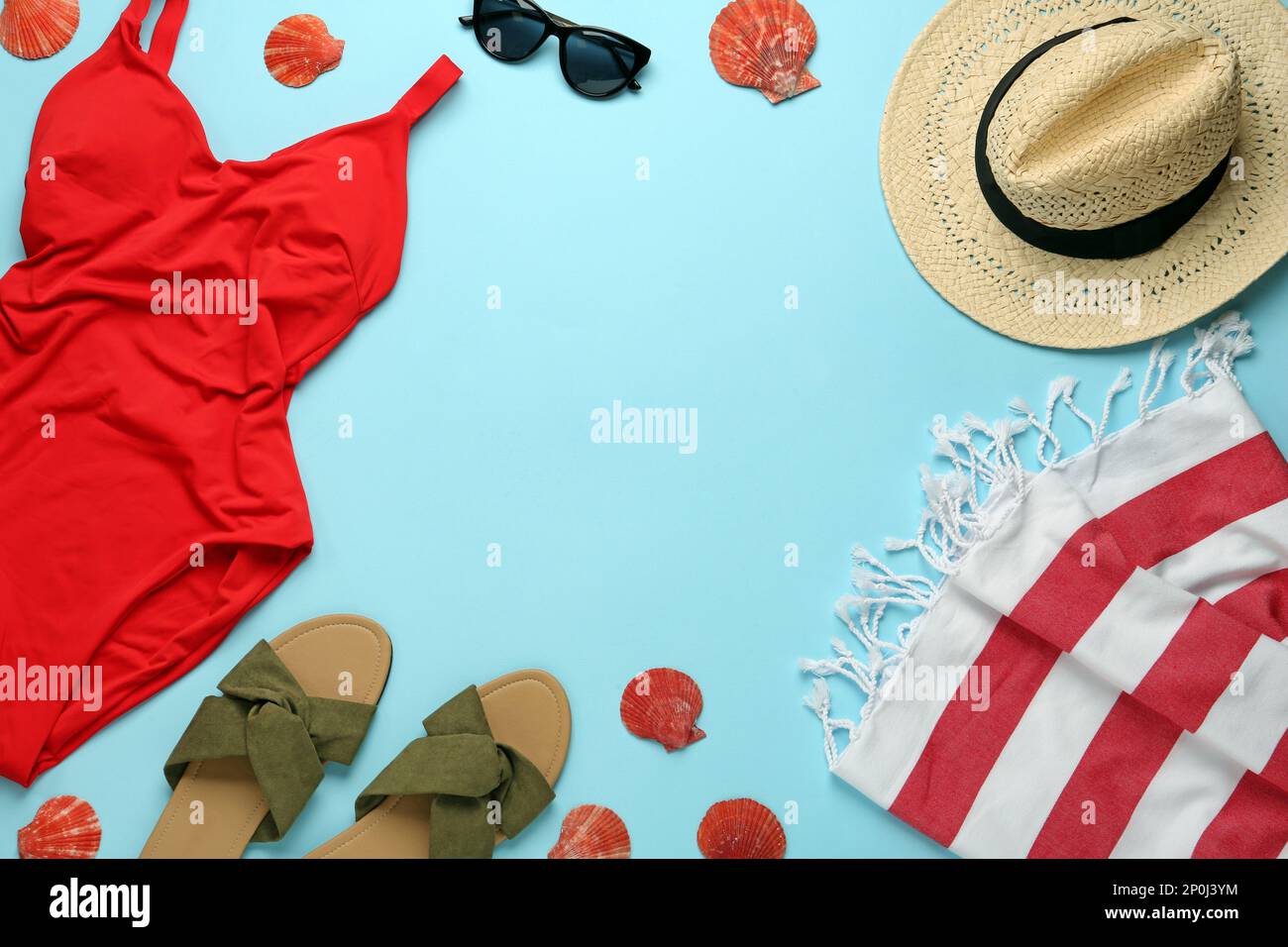 Frame made with different beach objects on light blue background, flat lay. Space for text Stock Photo