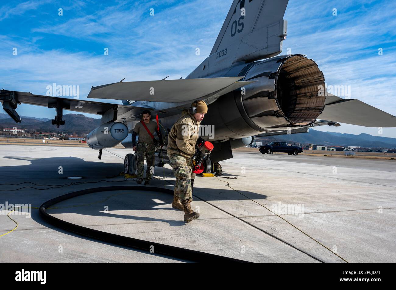 U.S. Air Force Senior Airman Brian Ramirez-Fontanez, 51st Logistics Readiness Squadron fuels service controller and Senior Airman Angel Fuentes, 36th Fighter Generation Squadron crew chief, refuel an F-16 Fighting Falcon, prior to launching at Daegu Air Base, Republic of Korea, Jan. 31, 2023. The Airmen participated in a simulated deployment from Osan AB to Daegu to test their ability to conduct contingency operations in the defense of the ROK. Stock Photo