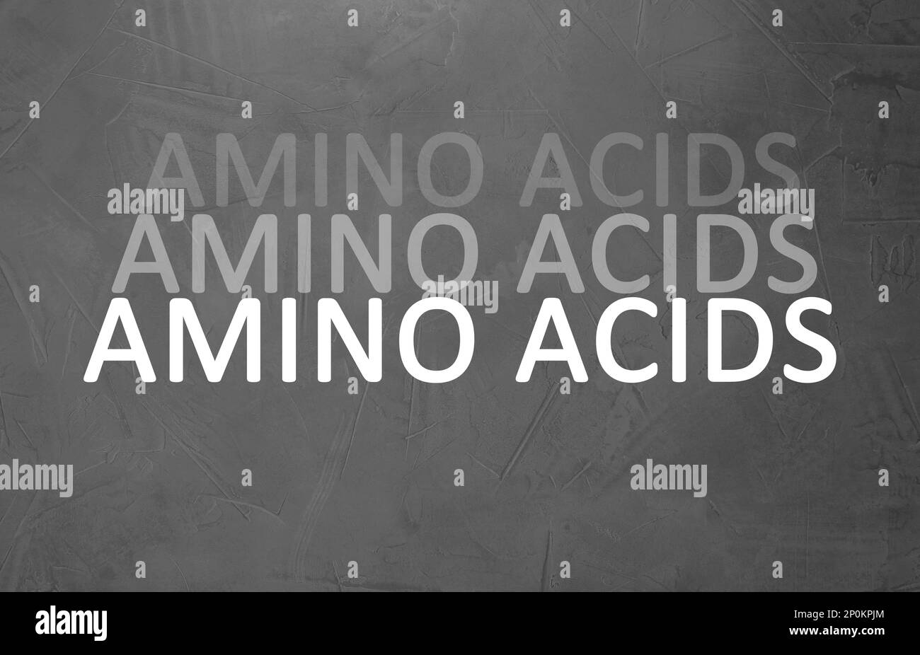 Text Amino Acids on grey stone surface Stock Photo