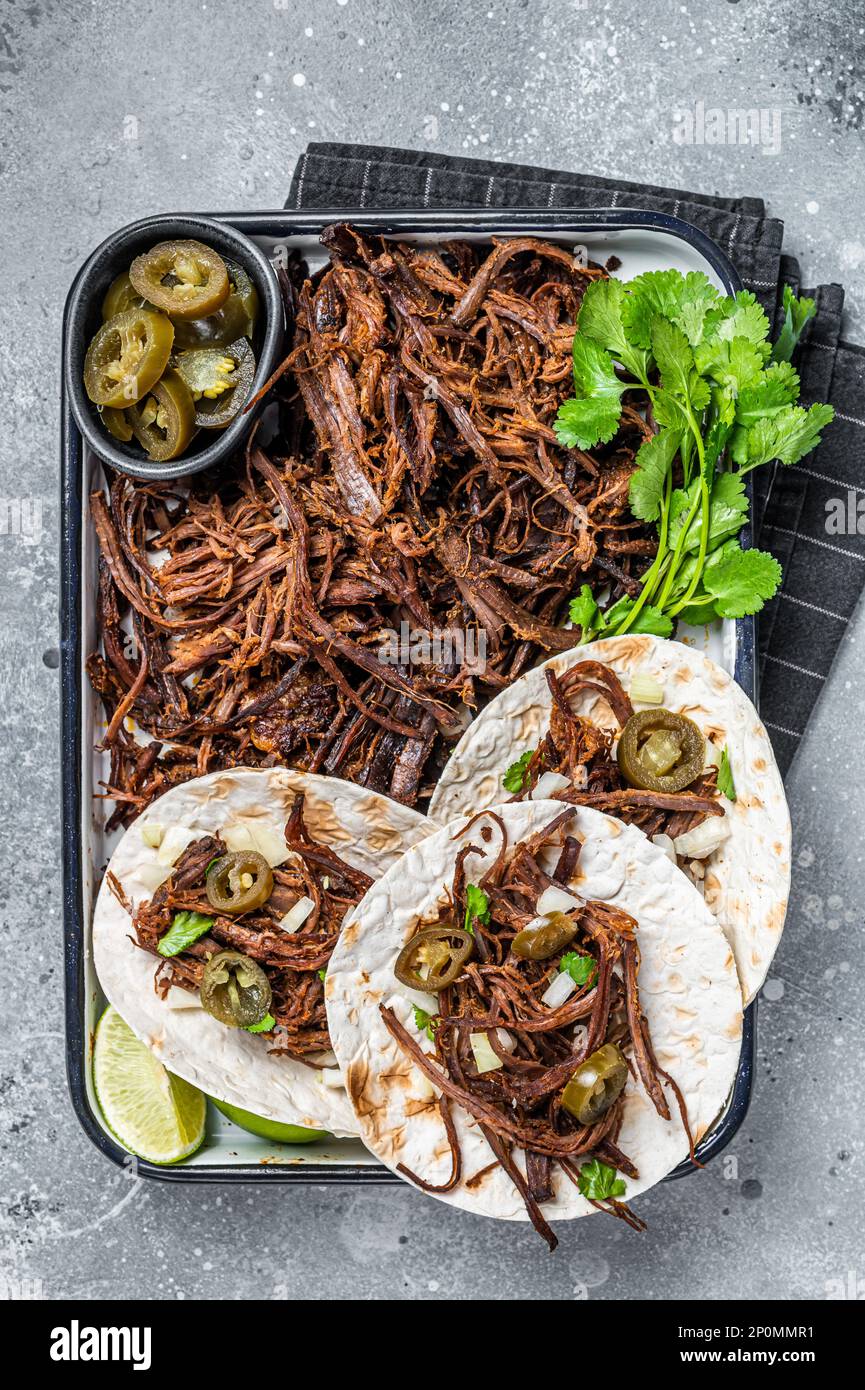 Cooking of Mexican lamb Barbacoa Tacos with Cilantro and Onion. Gray