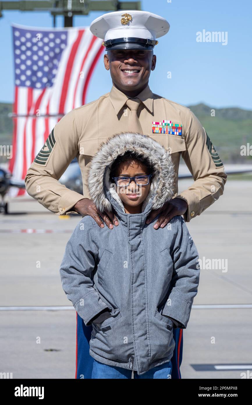 U.S. Marine Corps Sgt. Maj. Robert Catching, the incoming sergeant major for Headquarters and Headquarters Squadron, Marine Corps Air Station Camp Pendleton, and his son pose for a photo after a relief and appointment ceremony on MCAS Camp Pendleton, California, Feb. 15, 2023. Catching relieved Sgt. Maj. David Gonzalez, the outgoing sergeant major for H&HS, MCAS Camp Pendleton, of his duties. Stock Photo