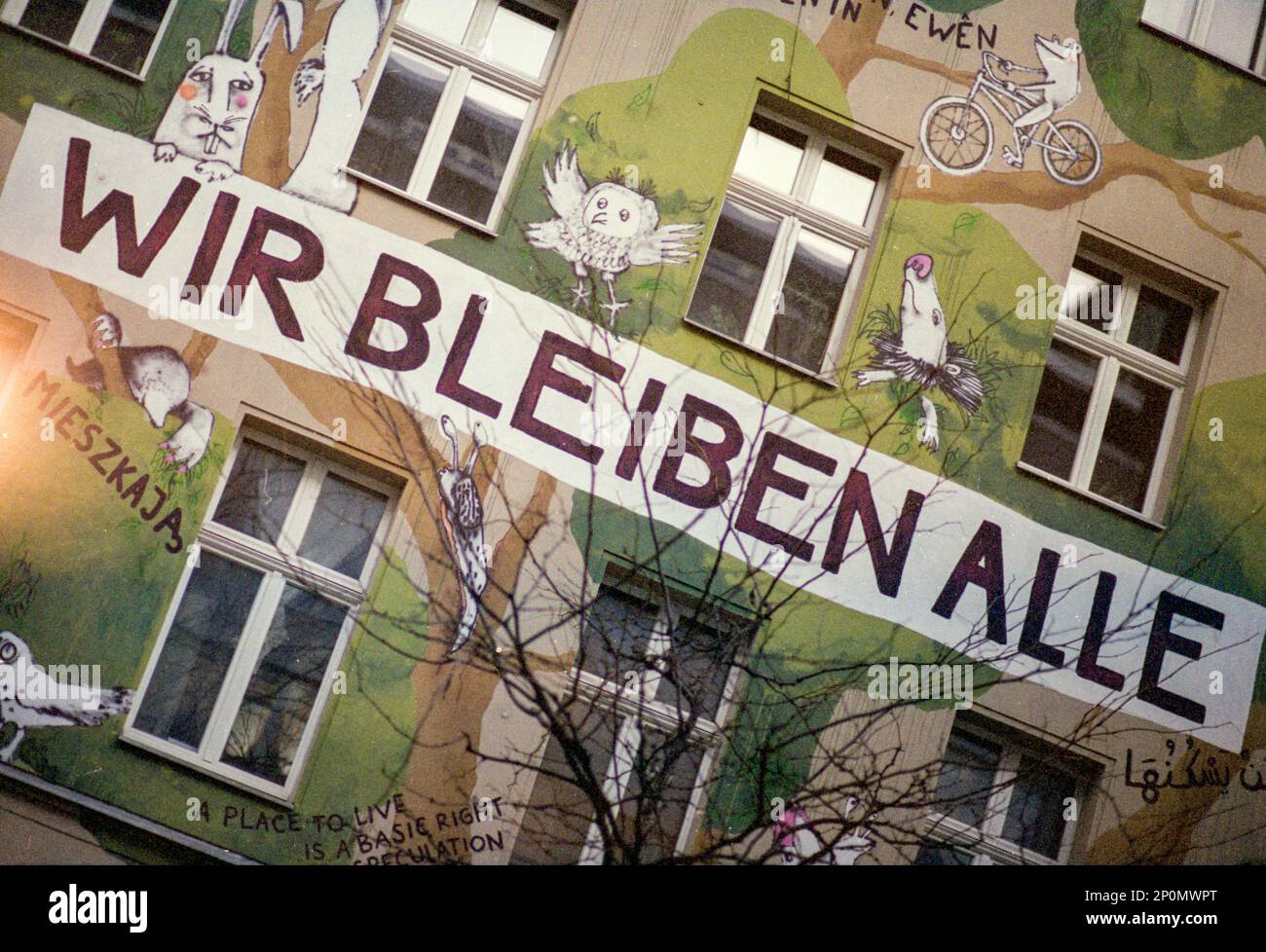 Berlin, Germany. FAcade of a Kreuzberg based squad, wheere the people who live inside, are motivated to stay. They consider the building rightfully theirs, since  everyone has a Right To Live. 'Wir Bleiben Alle' Stock Photo