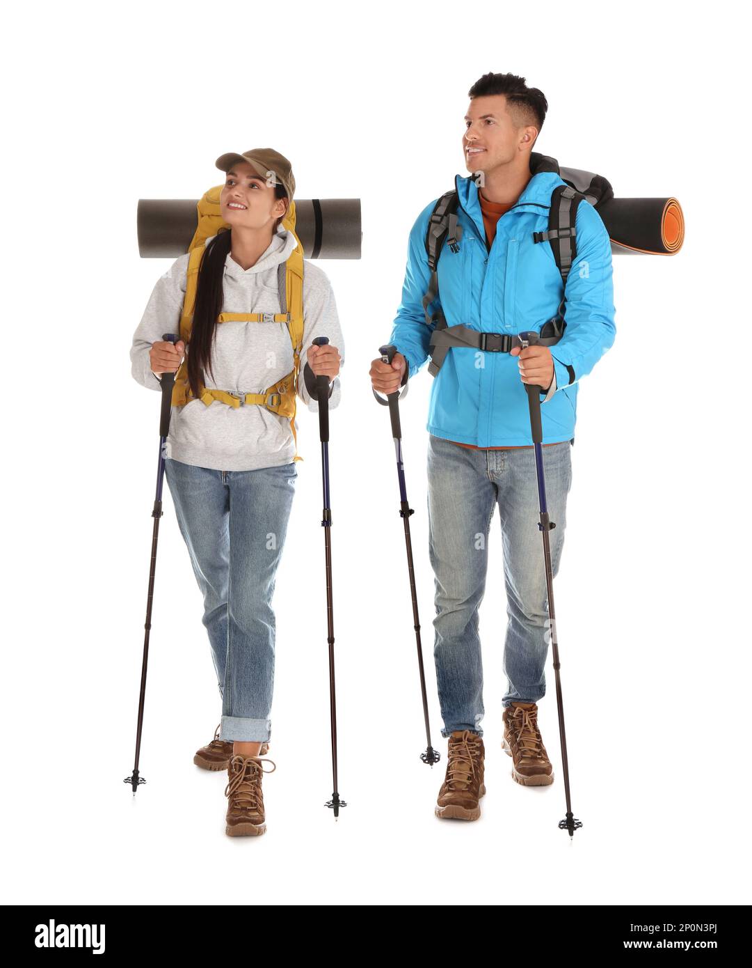 Couple of hikers with backpacks and trekking poles on white background Stock Photo