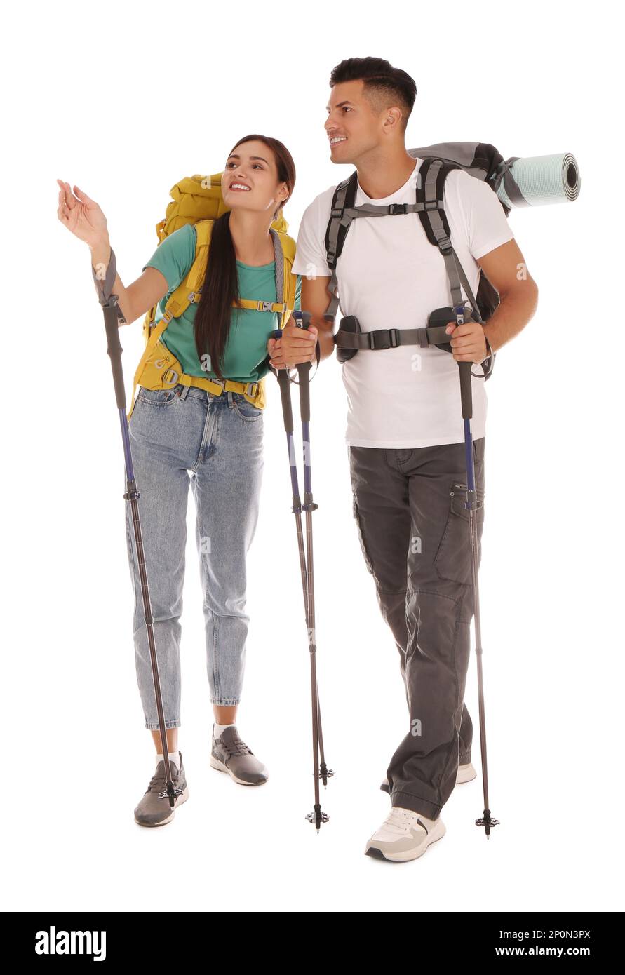 Couple of hikers with backpacks and trekking poles on white background Stock Photo