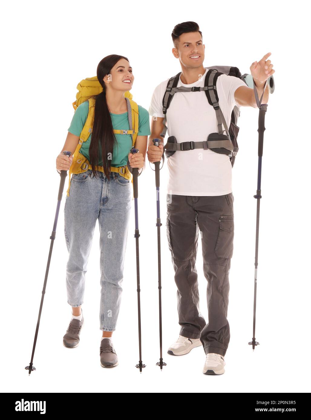 Couple of hikers with backpacks and trekking poles on white background Stock Photo