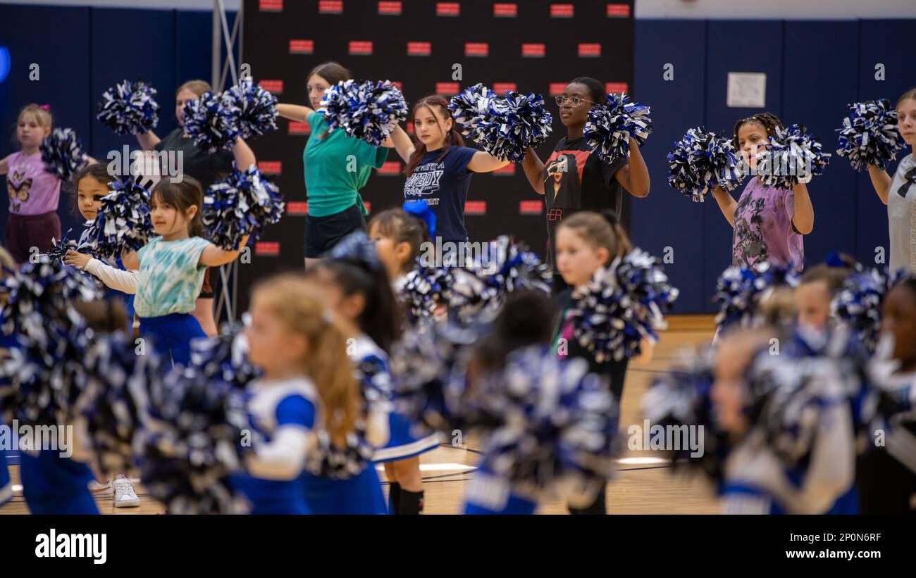 Professional National Football League cheerleaders and Marine Corps Air  Station Iwakuni children pose for a group photo during the Pro Blitz Cheer  Clinic on MCAS Iwakuni, Japan, Feb. 12, 2023. The Armed