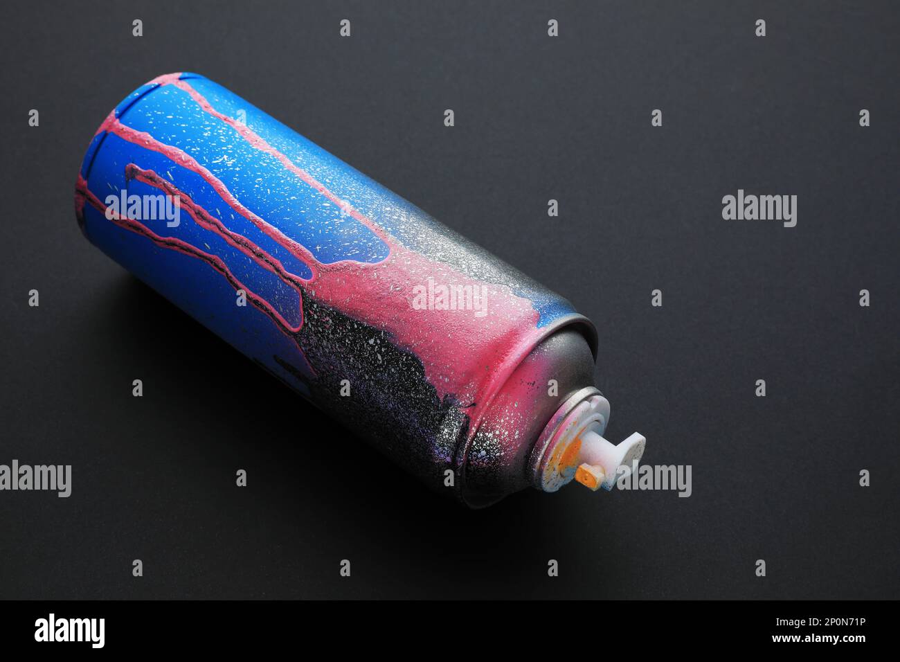 Used can of spray paint on black background. Graffiti supply Stock ...