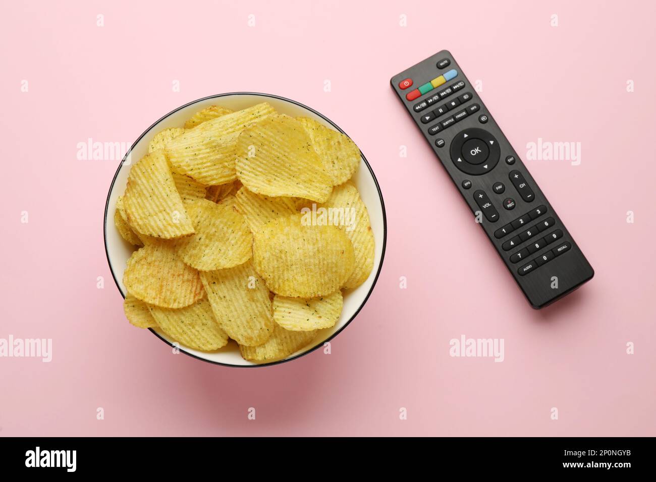 Conroll Chips Remote control and bowl of potato chips on pink background, flat lay ...