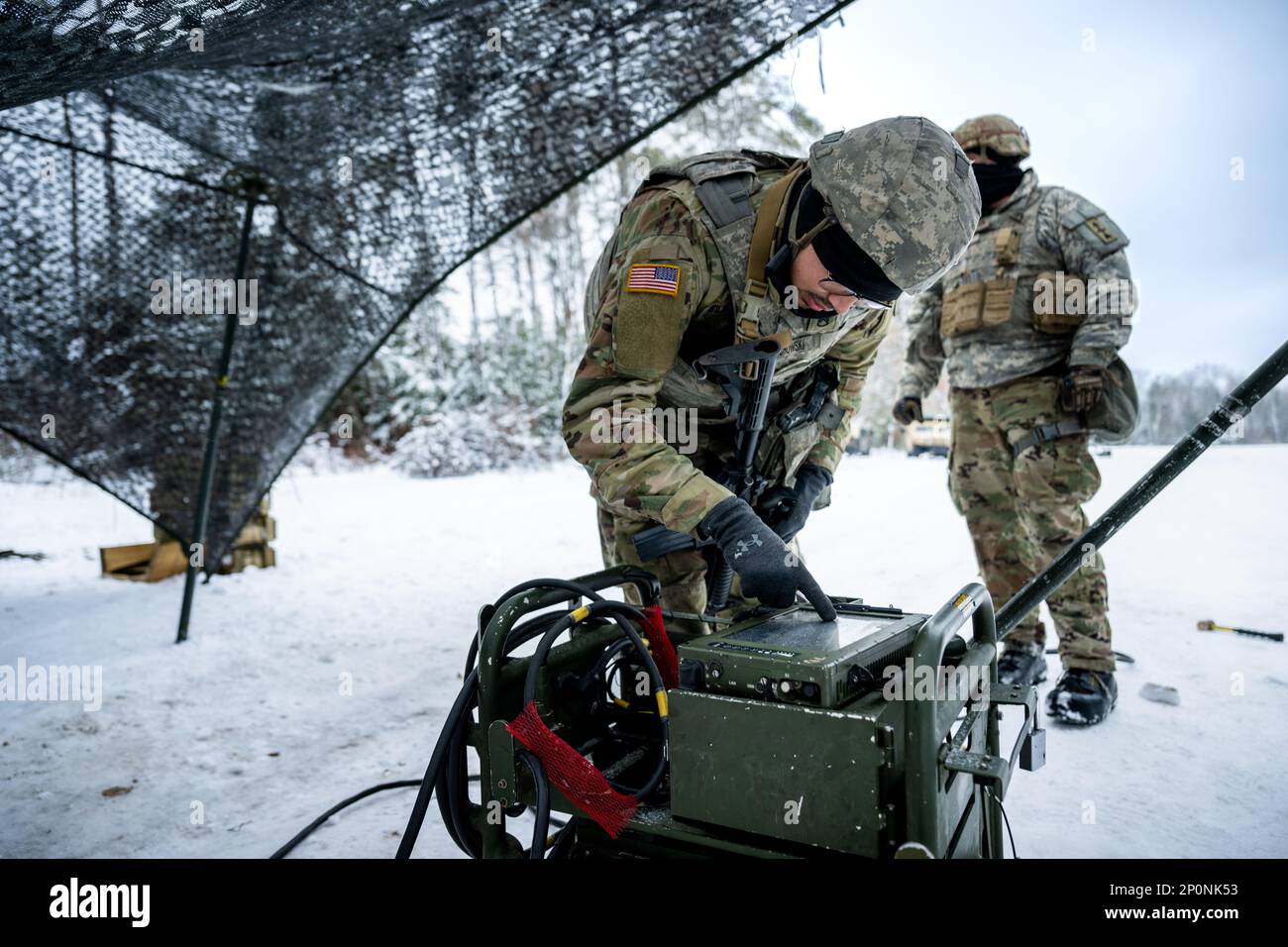 Army Staff Sgt. Ryan Wilichowski, 1-120th Field Artillery Regiment, responses to a message while setting up an M119 howitzer during Northern Strike 23-1, Jan. 25, 2023, at Camp Grayling, Mich. Units that participate in Northern Strike’s winter iteration build readiness by conducting joint, cold-weather training designed to meet objectives of the Department of Defense’s Arctic Strategy. Stock Photo