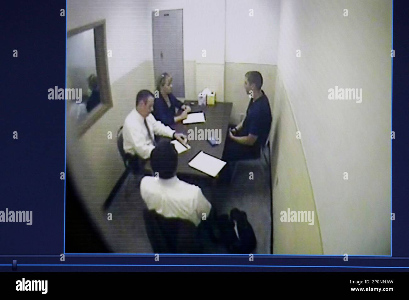 A photo of a video monitor showing Cincinnati Police Dept. Sgt. Shannon  Heine and another Cincinnati police representative interviewing Ray  Tensing, right, is shown in the courtroom of Common Pleas Judge Megan