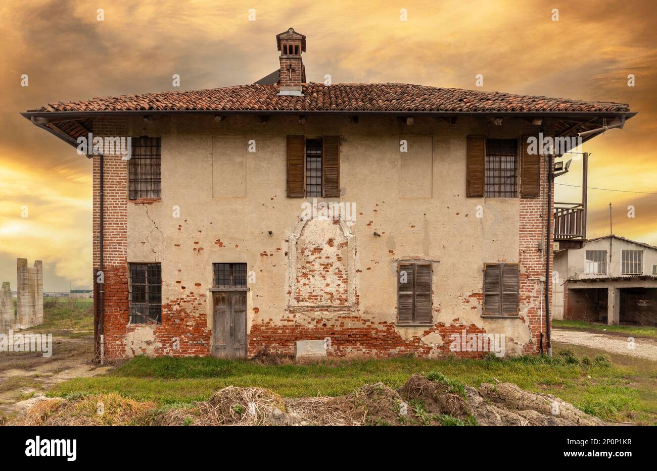 Old abandoned farmhouse with typical rural architecture of the Po Valley in the province of Cuneo, Italy Stock Photo