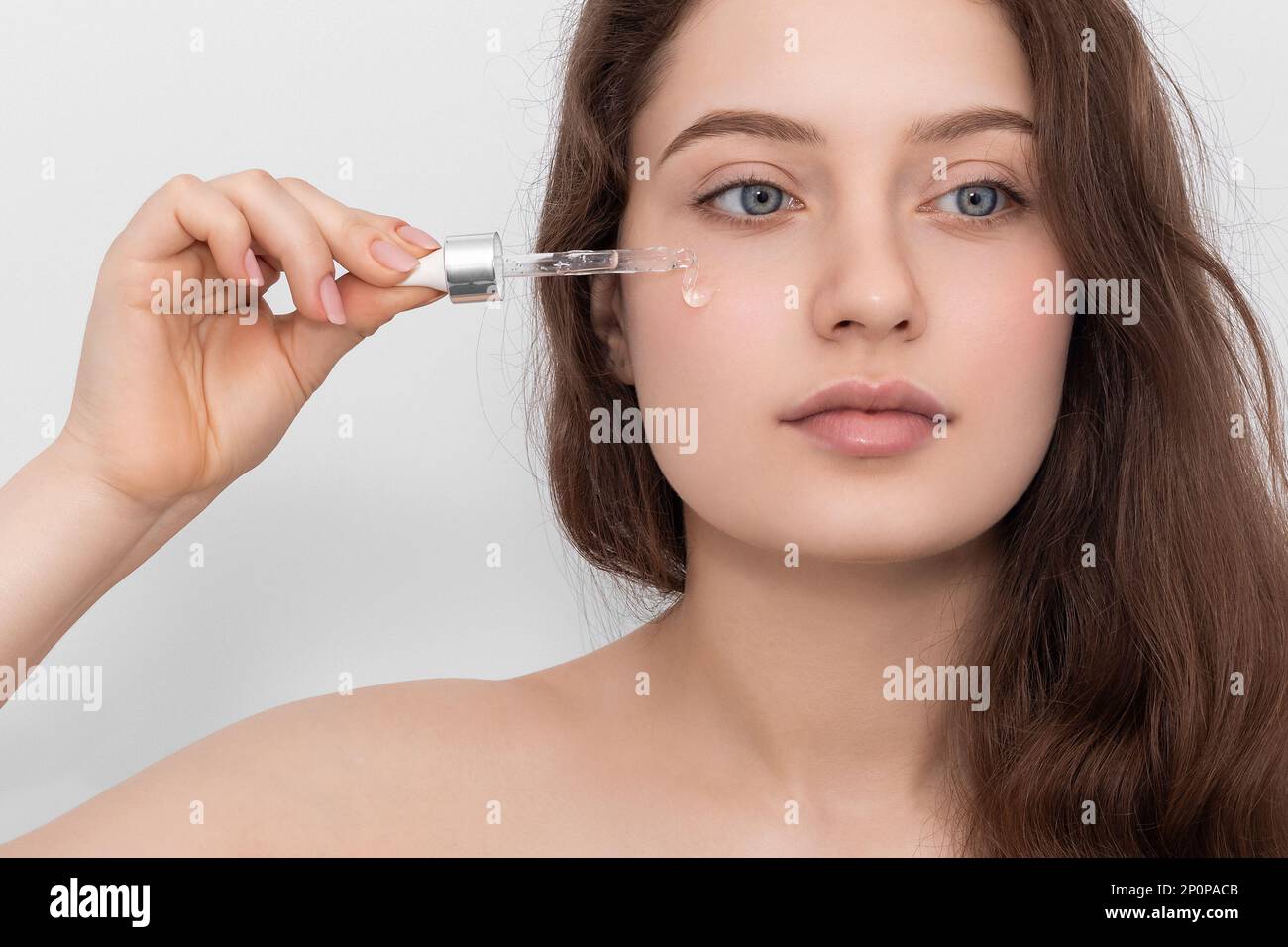 Woman applying serum hi-res stock photography and images - Alamy