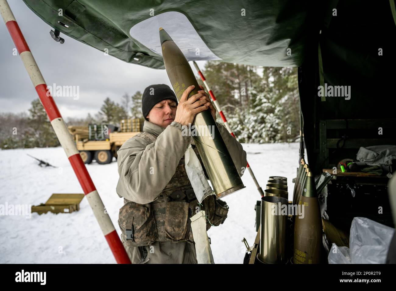 Army Cpl. Brady Kielpikowski, 1-120th Field Artillery Regiment, assembles a 105mm High Explosive shell to be used with the M119 howitzer during Northern Strike 23-1, Jan. 23, 2023, at Camp Grayling, Mich. Units that participate in Northern Strike’s winter iteration build readiness by conducting joint, cold-weather training designed to meet objectives of the Department of Defense’s Arctic Strategy. Stock Photo