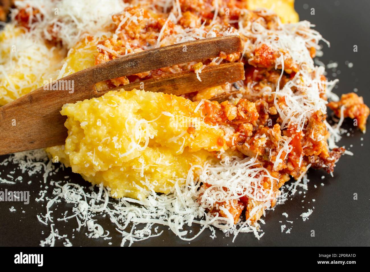 Boiled corn flour, polenta, with minced pork meat and tomato sauce, ragu, soft focus close up texture Stock Photo