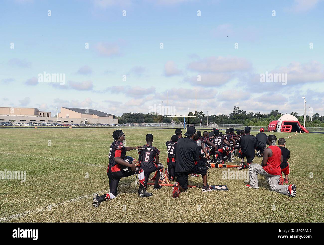 In this Saturday, Sept. 17, 2016 photo, members of the Beaumont Bulls youth football team and