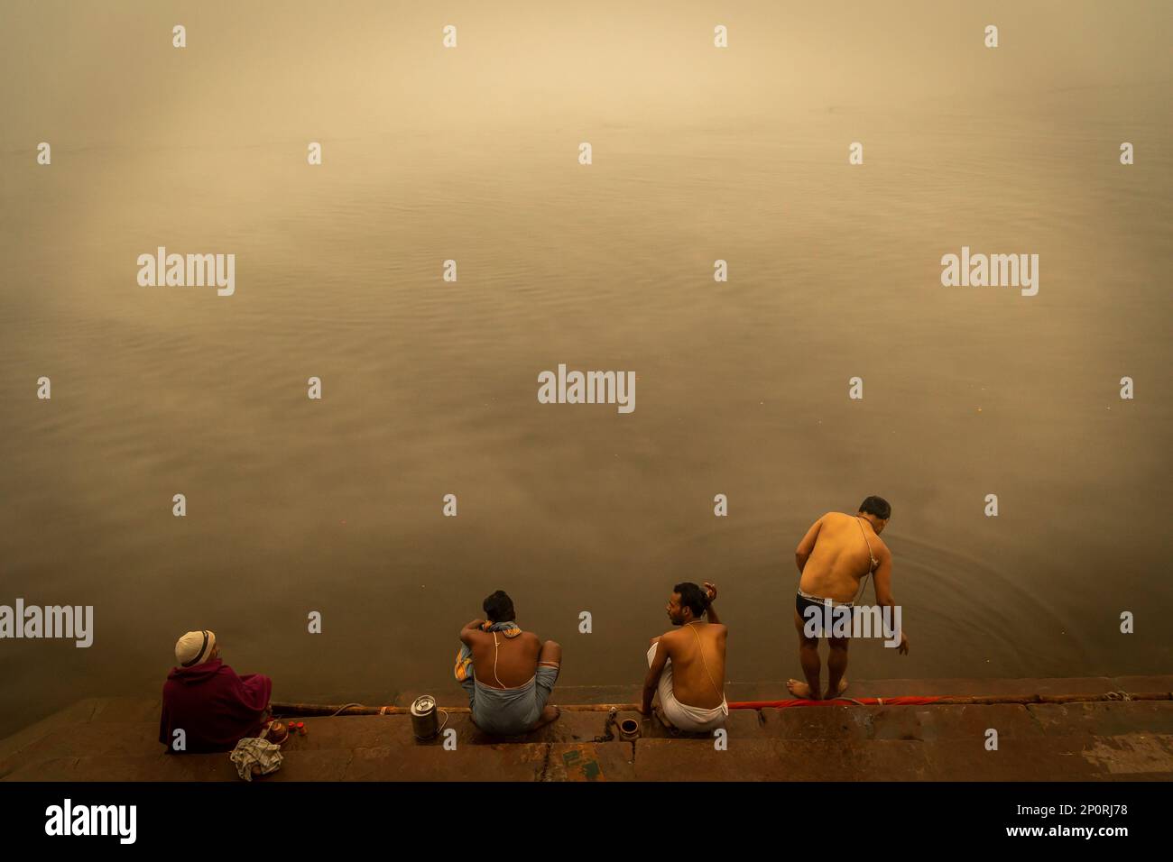 Devotees taking early morning bath in Ganga river, Varanasi Stock Photo