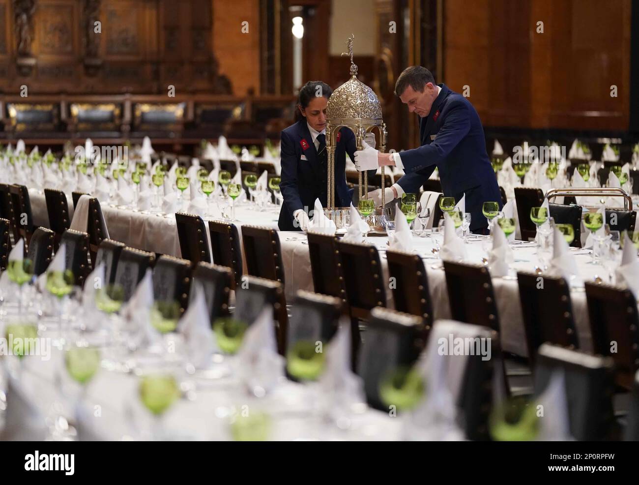 Hamburg, Germany. 03rd Mar, 2023. Council servant Nadine Petermann and council servant Holger Schmidtke set the tables in the Great Banqueting Hall during the final preparations for the traditional Matthiae meal of the Hamburg Senate at City Hall. The Matthiae meal is considered the oldest guest banquet still celebrated in the world. Credit: Marcus Brandt/dpa/Alamy Live News Stock Photo