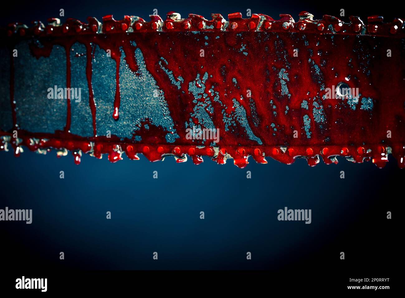 chainsaw stained with blood dark background Stock Photo