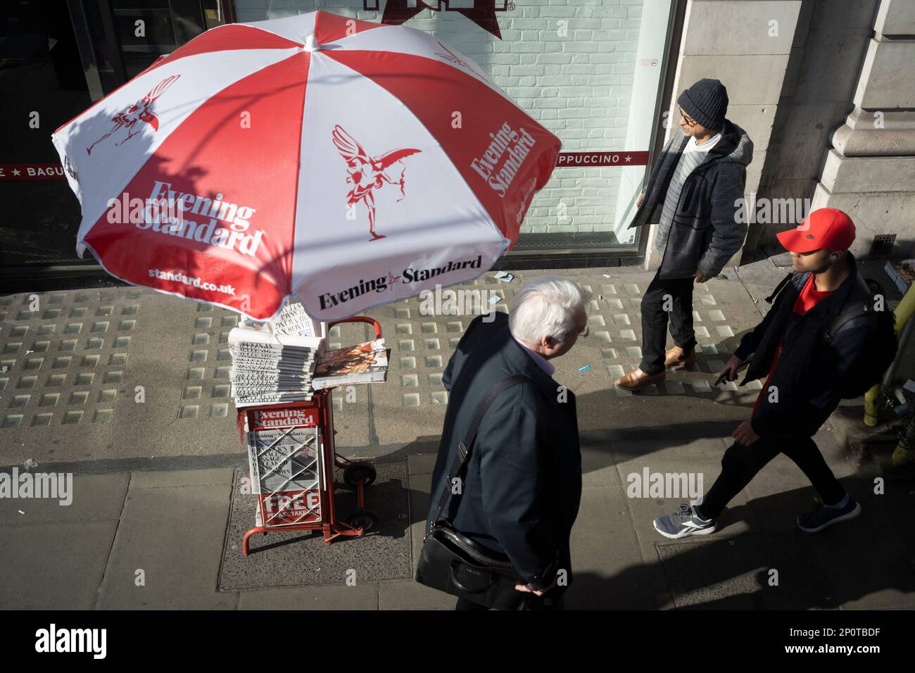 Evening Standard newspapers are free to take from under a sun parasol on Piccadilly, on 2nd March 2023, in London, England. Stock Photo