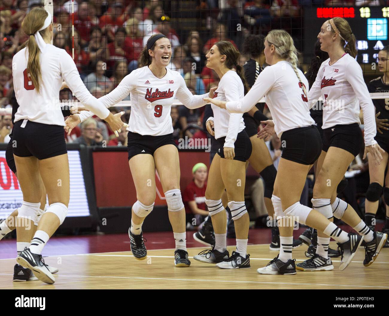 Nebraska players celebrate during the third set of a college volleyball