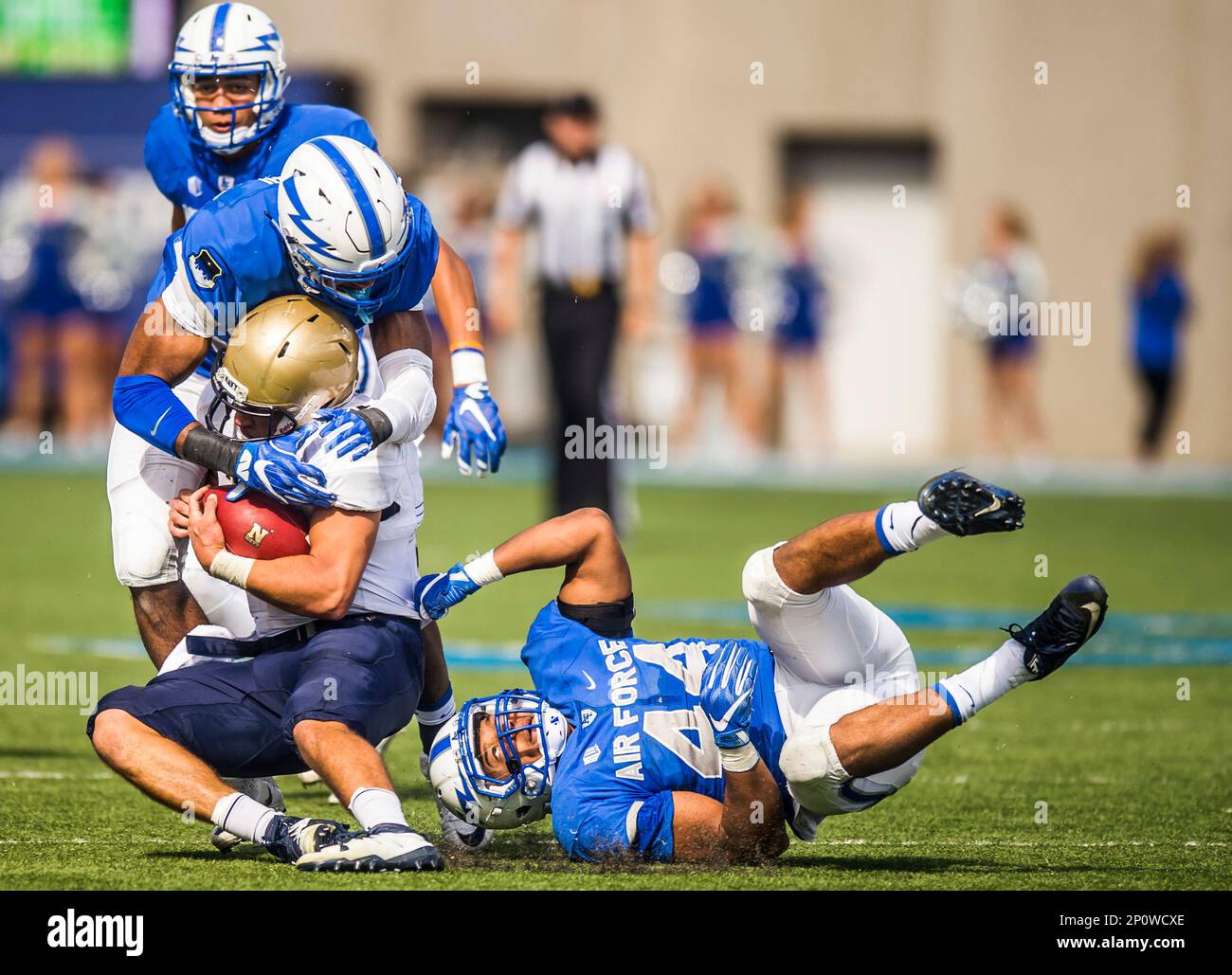 Navy quarterback Will Worth, lower left, is tackled by Air Force