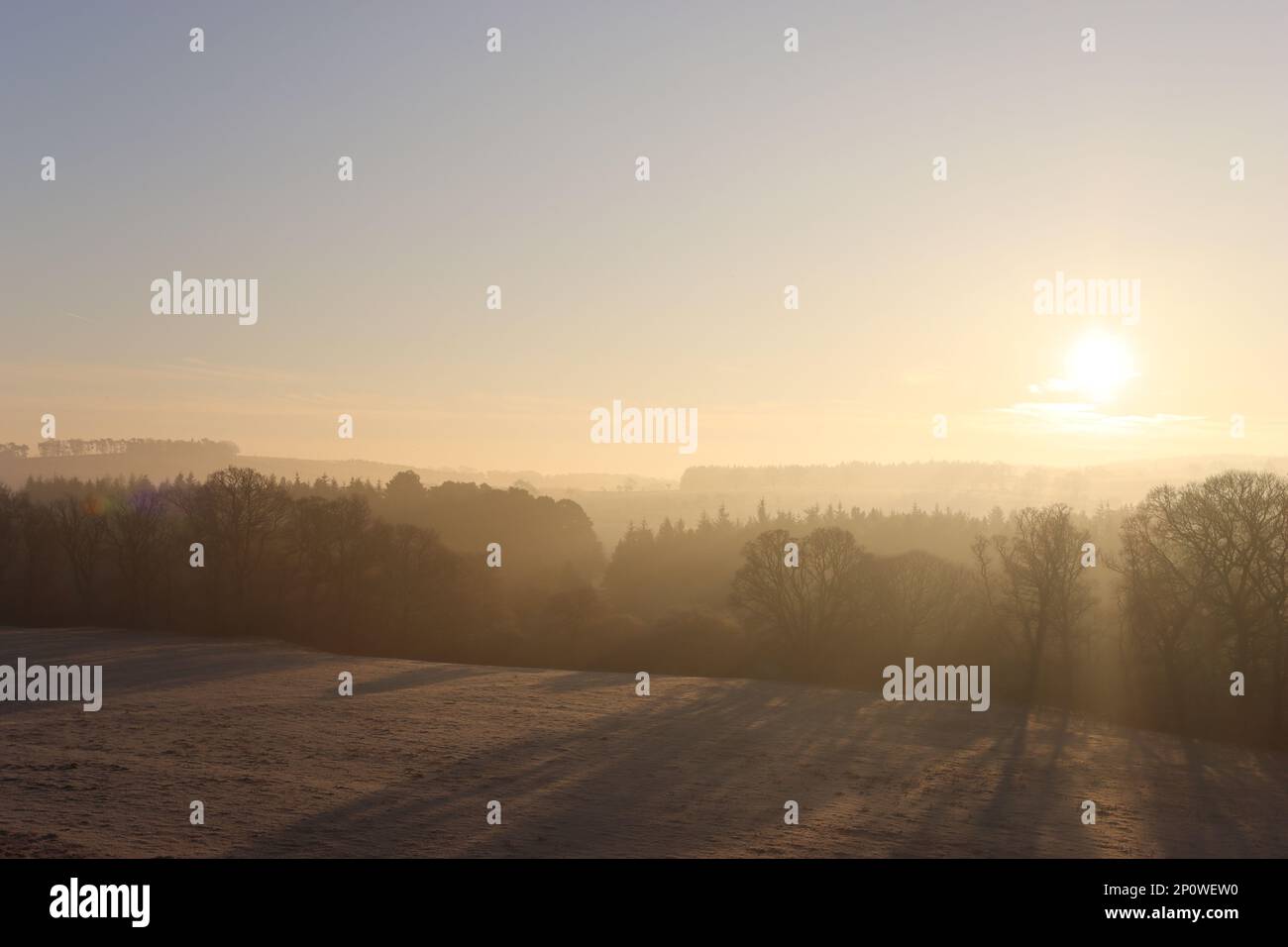 Sunrise over a frost covered countryside landscape Stock Photo
