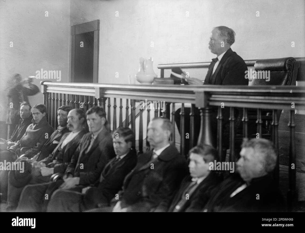 Feud - Scenes in Virginia Mountain Town at Trial After Feud, 1912. Judge Walter R. Staples in court; possibly a reenactment of the shooting of the first judge. Photo taken in Carroll County, Virginia, between March and May 1912. Related to second trial of Floyd Allen after he killed the judge at his first trial. Landowner Floyd Allen was convicted and executed for murder in 1913 after a courthouse shootout the previous year that left a judge, prosecutor, sheriff, and two others dead. Stock Photo
