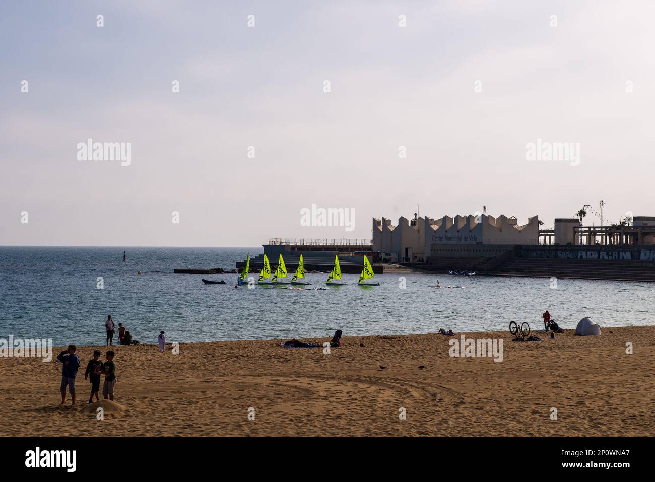 Barcelona,Spain-February 20,2023 : People enjoy a warm sunny afternoon playing at the beach. Stock Photo