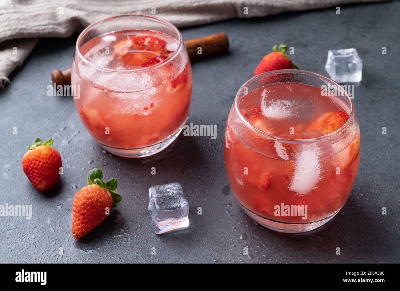 Brazilian strawberry caipirinha in glasses with ice and fruits over ...