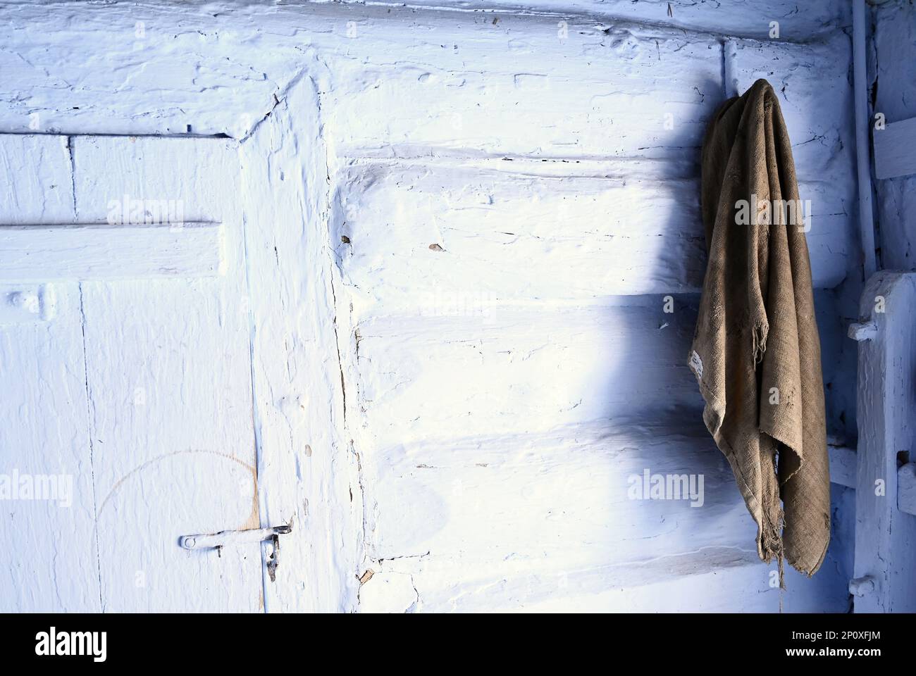 old rag hanging on a white wooden wall of old cottage Stock Photo - Alamy
