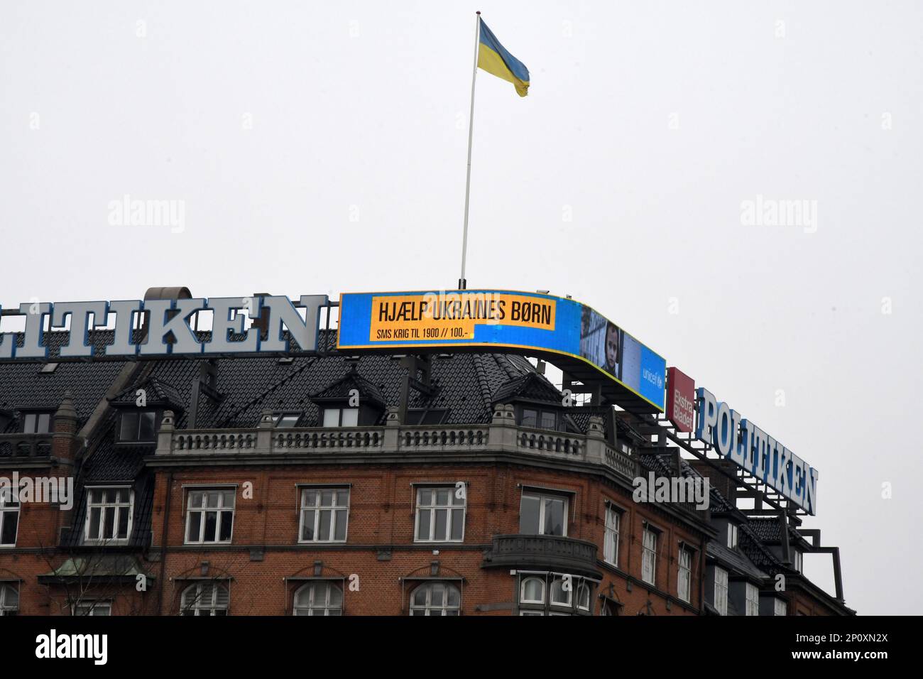 Copenhagen/Denmark/03 march 2023/ Danish media Politken hus fly ukrianian flag and neon sign one year Ukrian in war and help ukrianina children ..  (Photo. Francis Joseph Dean/Dean Pictures) Stock Photo