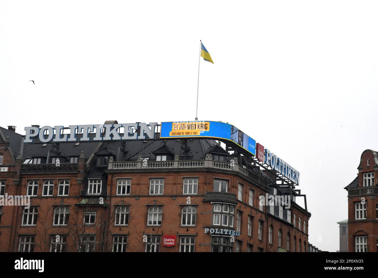 Copenhagen/Denmark/03 march 2023/ Danish media Politken hus fly ukrianian flag and neon sign one year Ukrian in war and help ukrianina children ..  (Photo. Francis Joseph Dean/Dean Pictures) Stock Photo