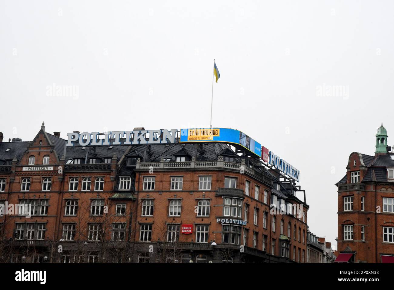 Copenhagen/Denmark/03 march 2023/ Danish media Politken hus fly ukrianian flag and neon sign one year Ukrian in war and help ukrianina children ..  (Photo. Francis Joseph Dean/Dean Pictures) Stock Photo