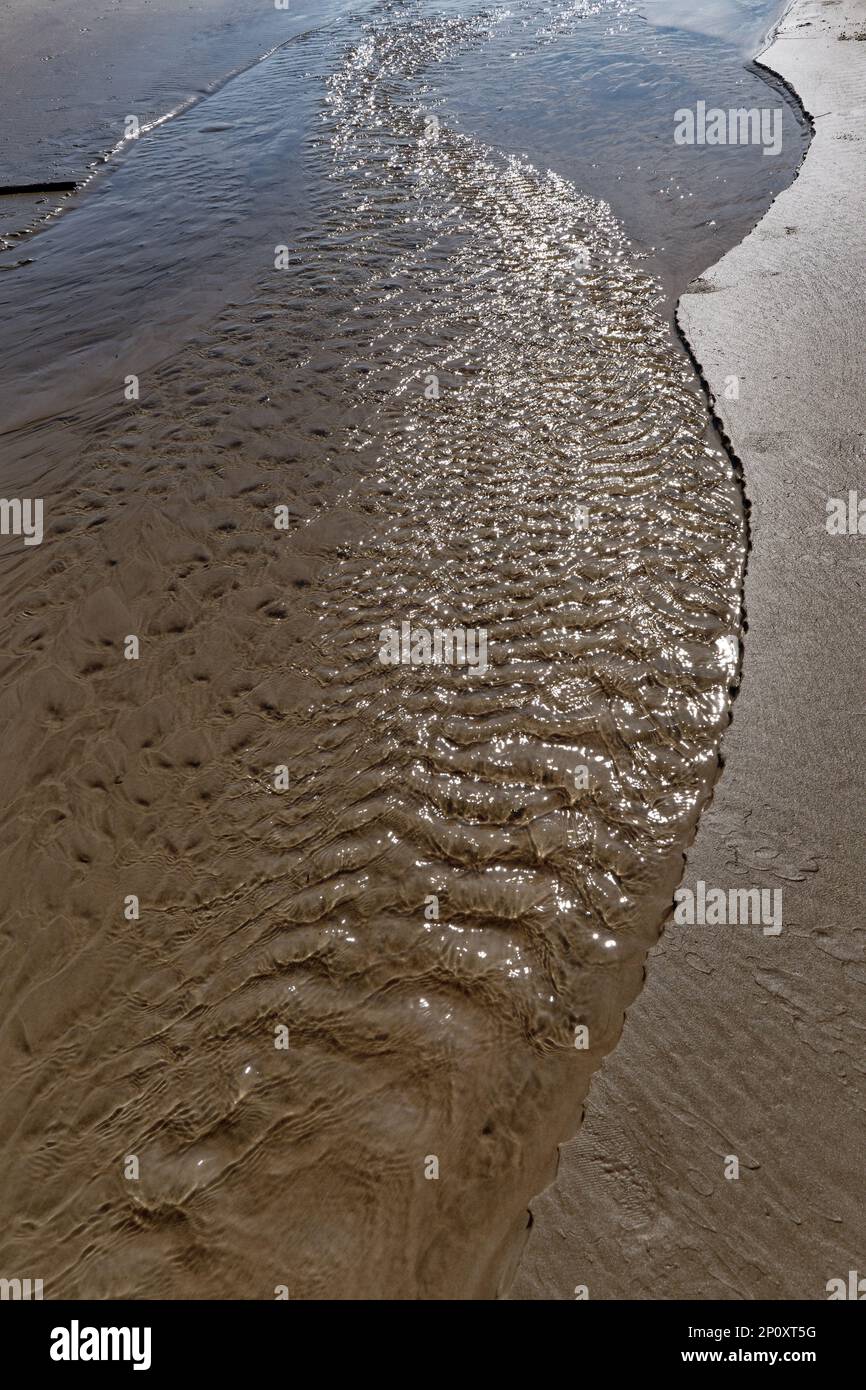 Waves gently lapping the shore Stock Photo