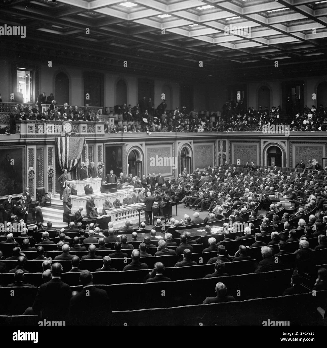 Opening of The 64th Congress 1915, Congressman Mann Introducing Speaker Clark, 1915. James Robert Mann (standing in front of flag, to the right) introduces Speaker of the House James Beauchamp Clark. Stock Photo