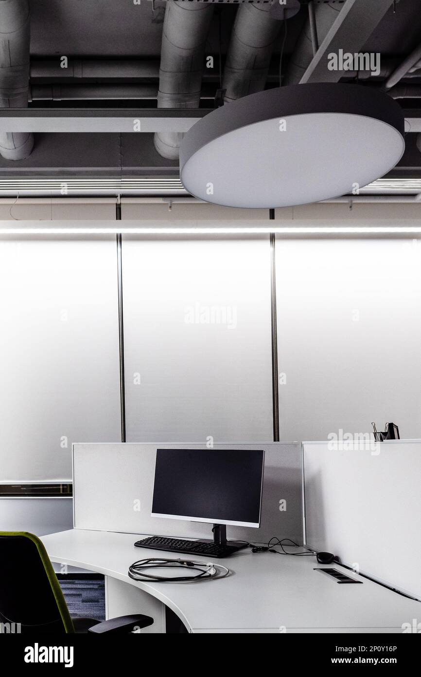 monochrome workplace in empty office in evening Stock Photo